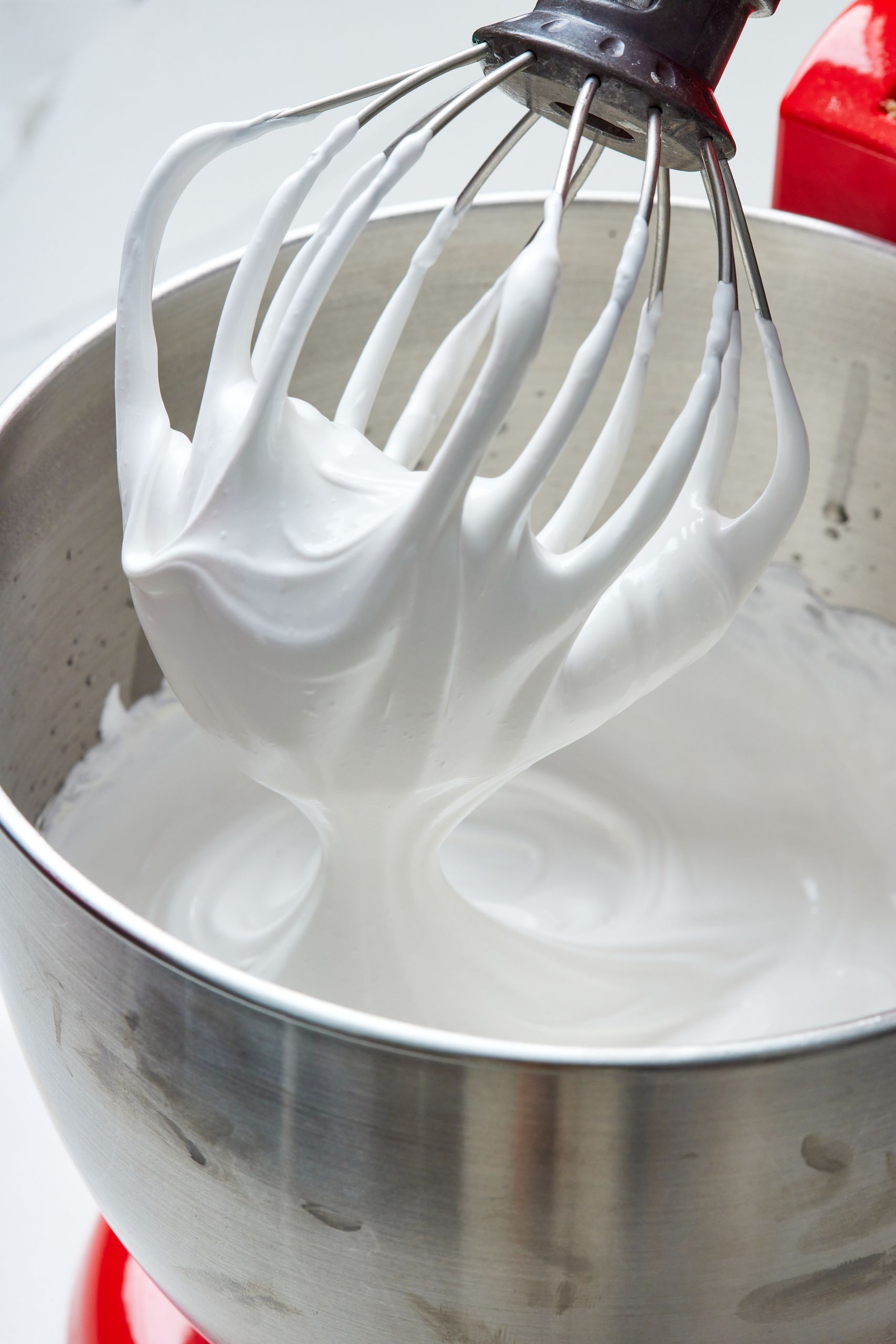 7 Minute Frosting in the bowl of a stand mixer with the whisk attachment. The frosting is silky smooth like meringue. 