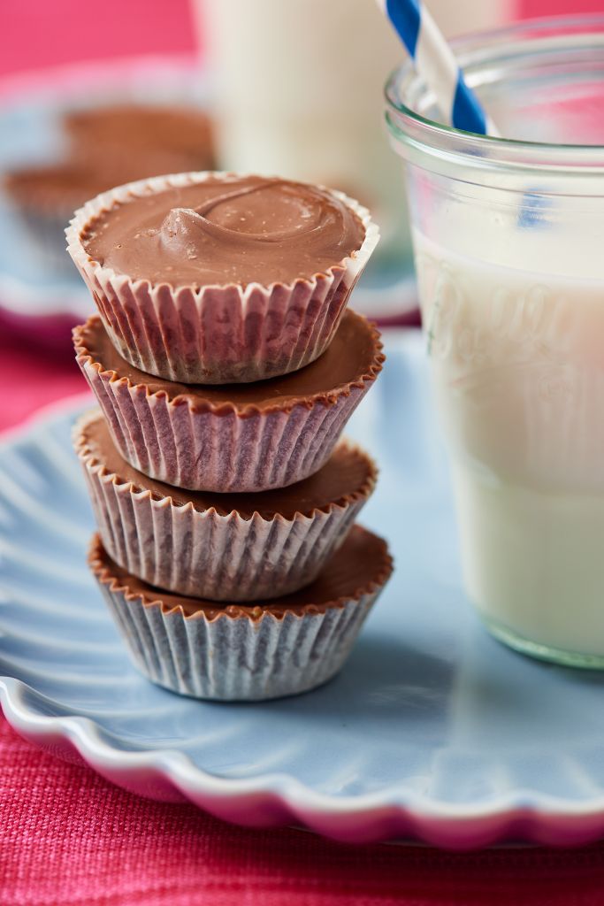 A stack of peanut butter cups served with milk