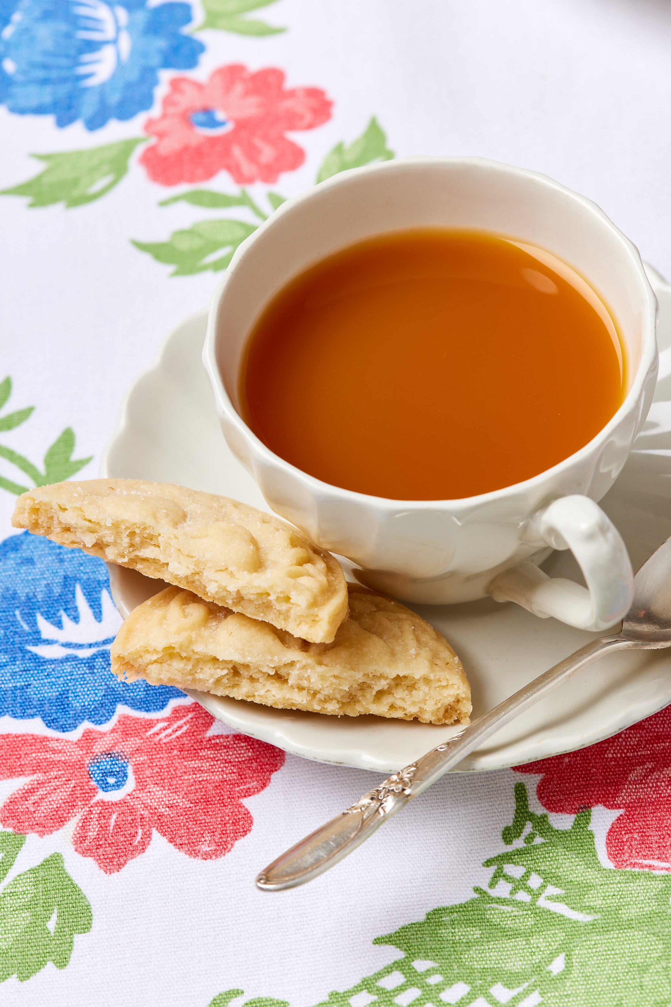 5 Ingredient Irish Shortbread13 A shortbread is broken into halves. The close-up shot shows its crumbly texture. Paired with a cup of tea.