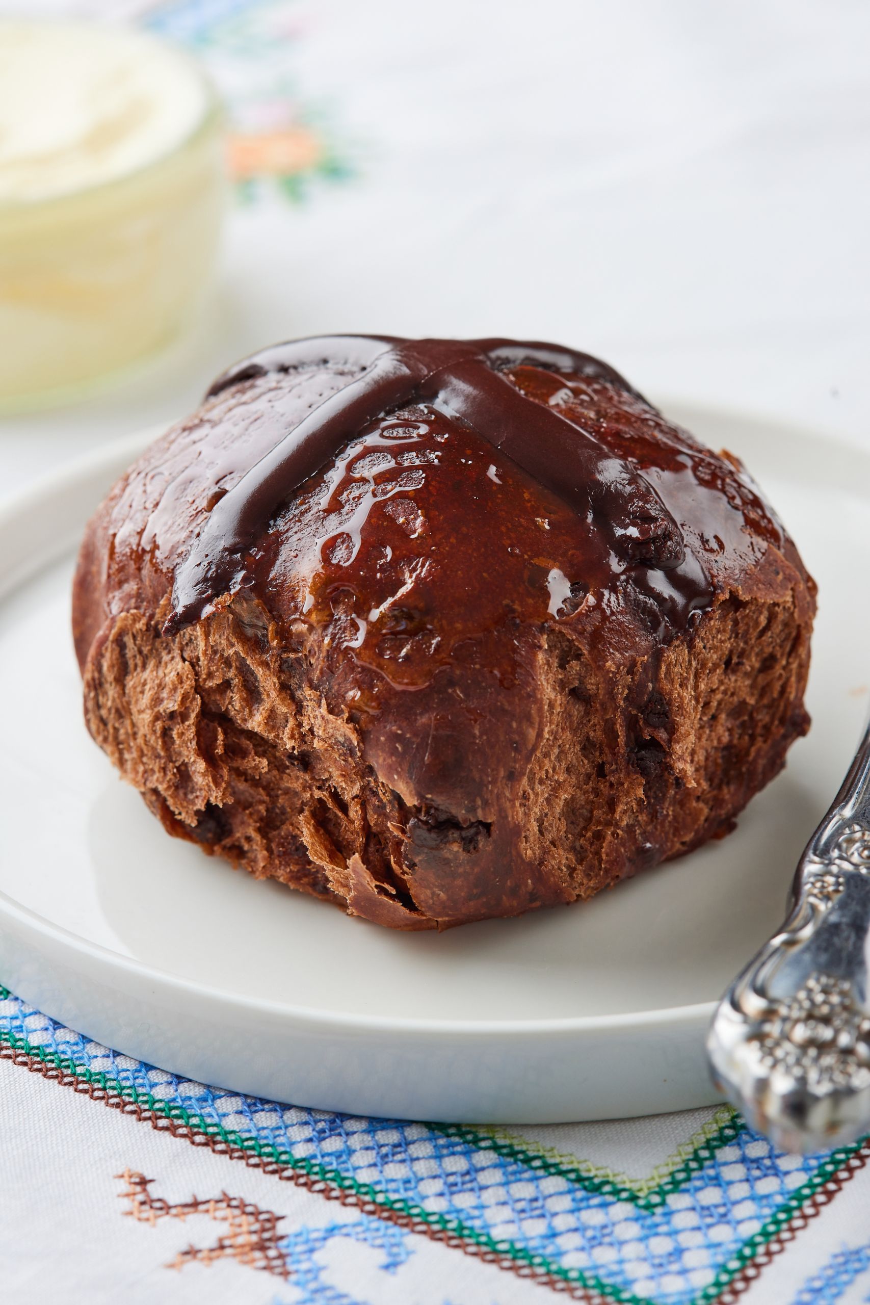 A close-up shot at a Chocolate Hot Cross bun. 