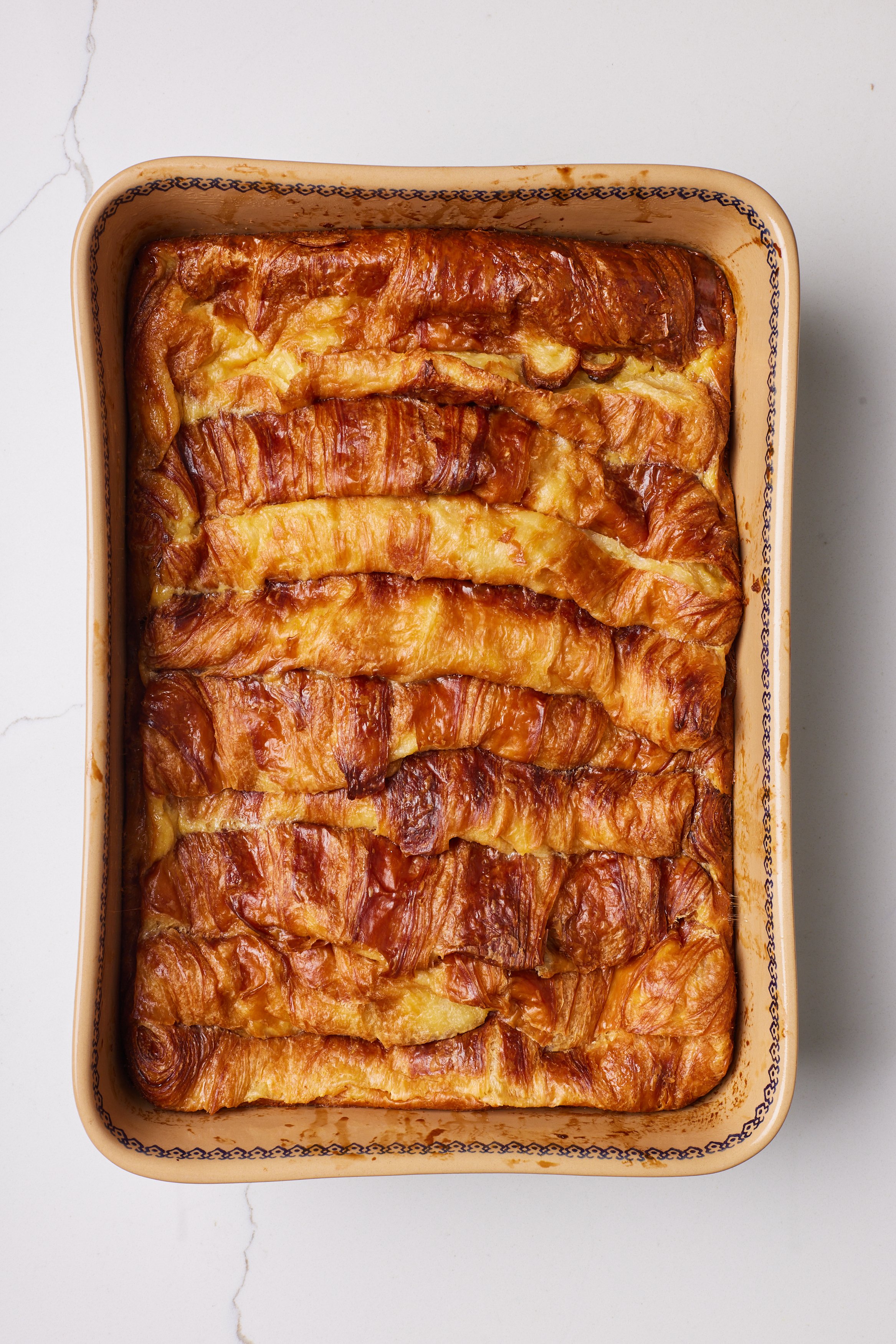 Bake the croissants with custard until the custard is set and the croissants are golden and crispy.