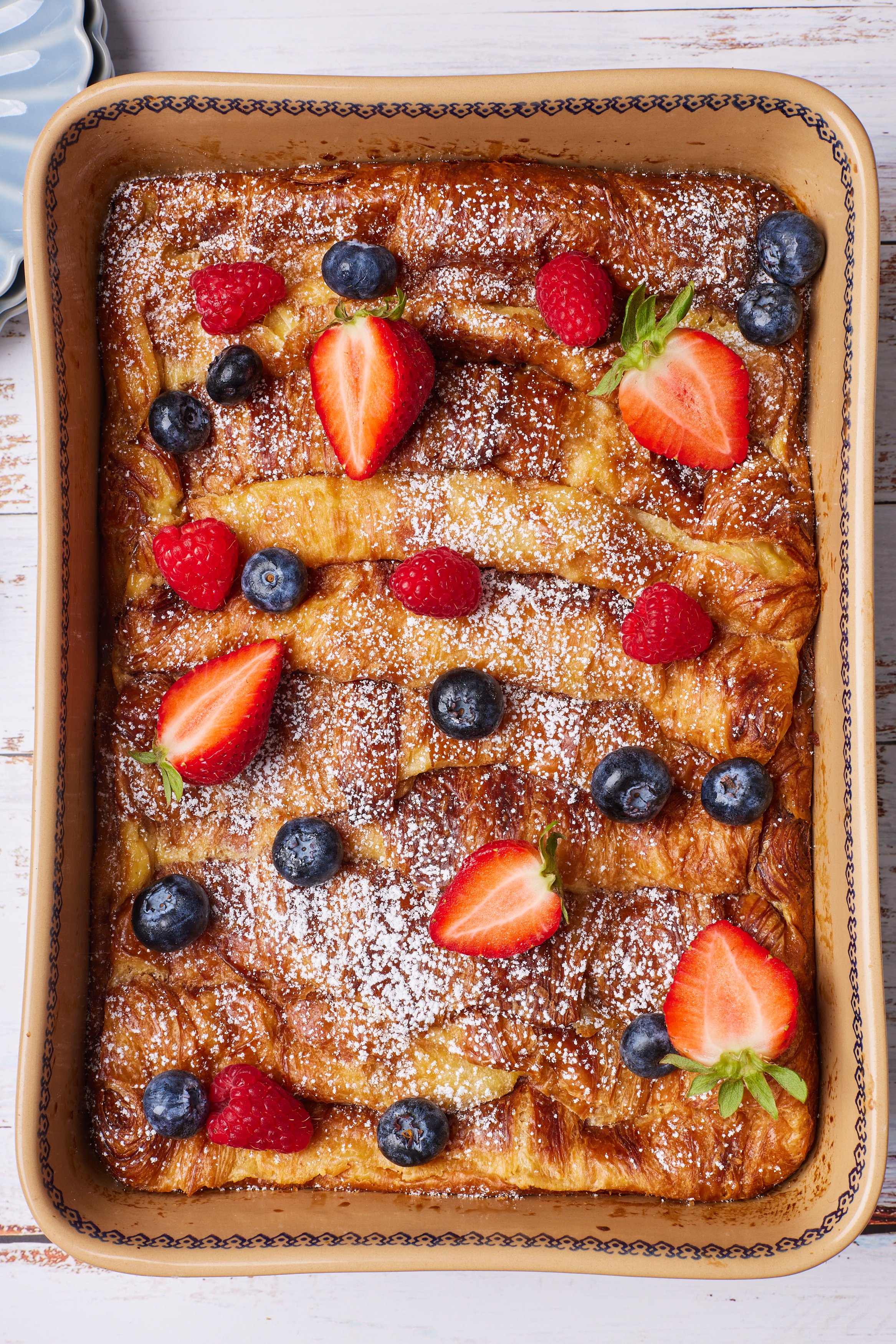 Serve the casserole with powdered sugar and fresh blueberries and strawberries 