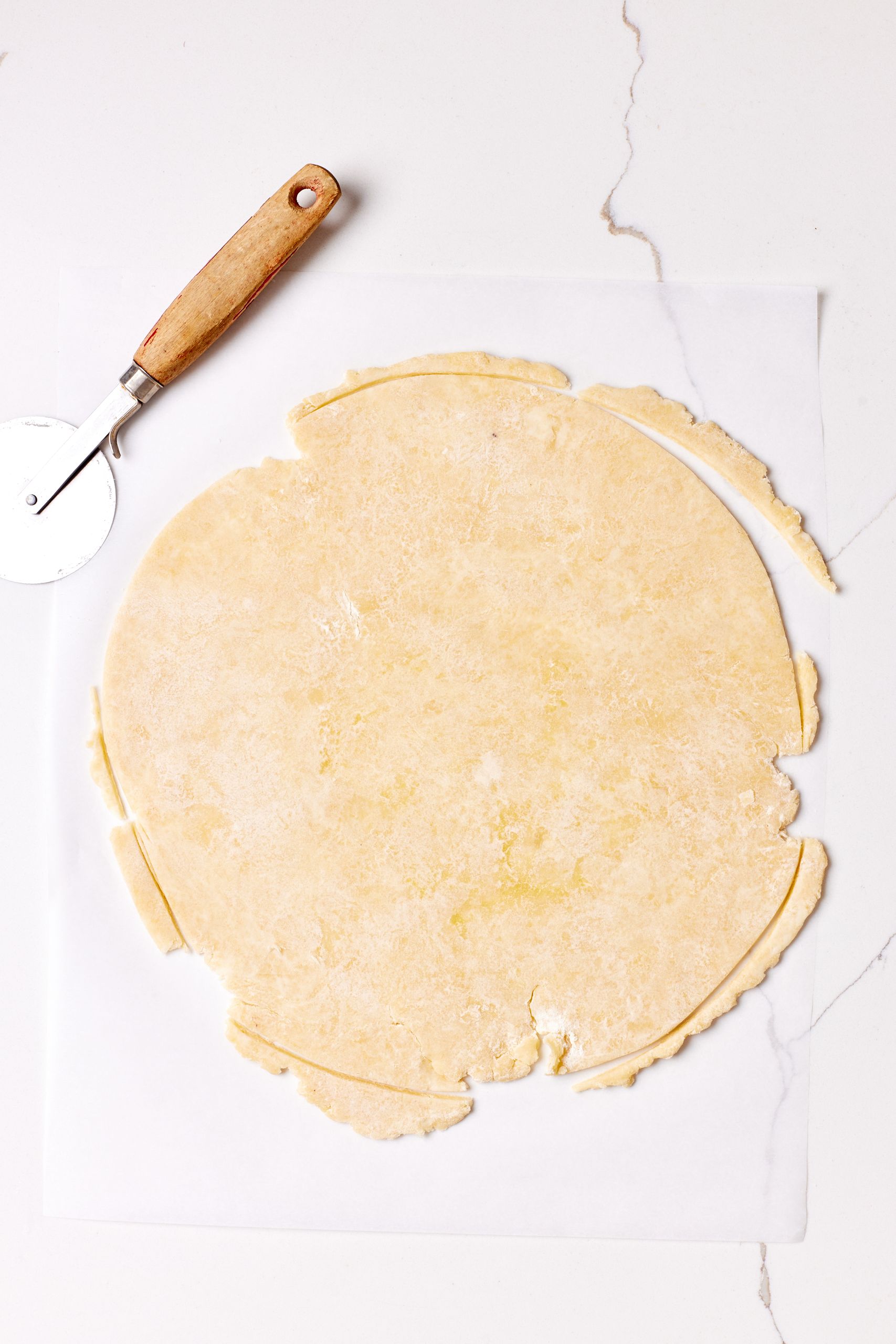 Roll out the crust and trim it into a circle. 