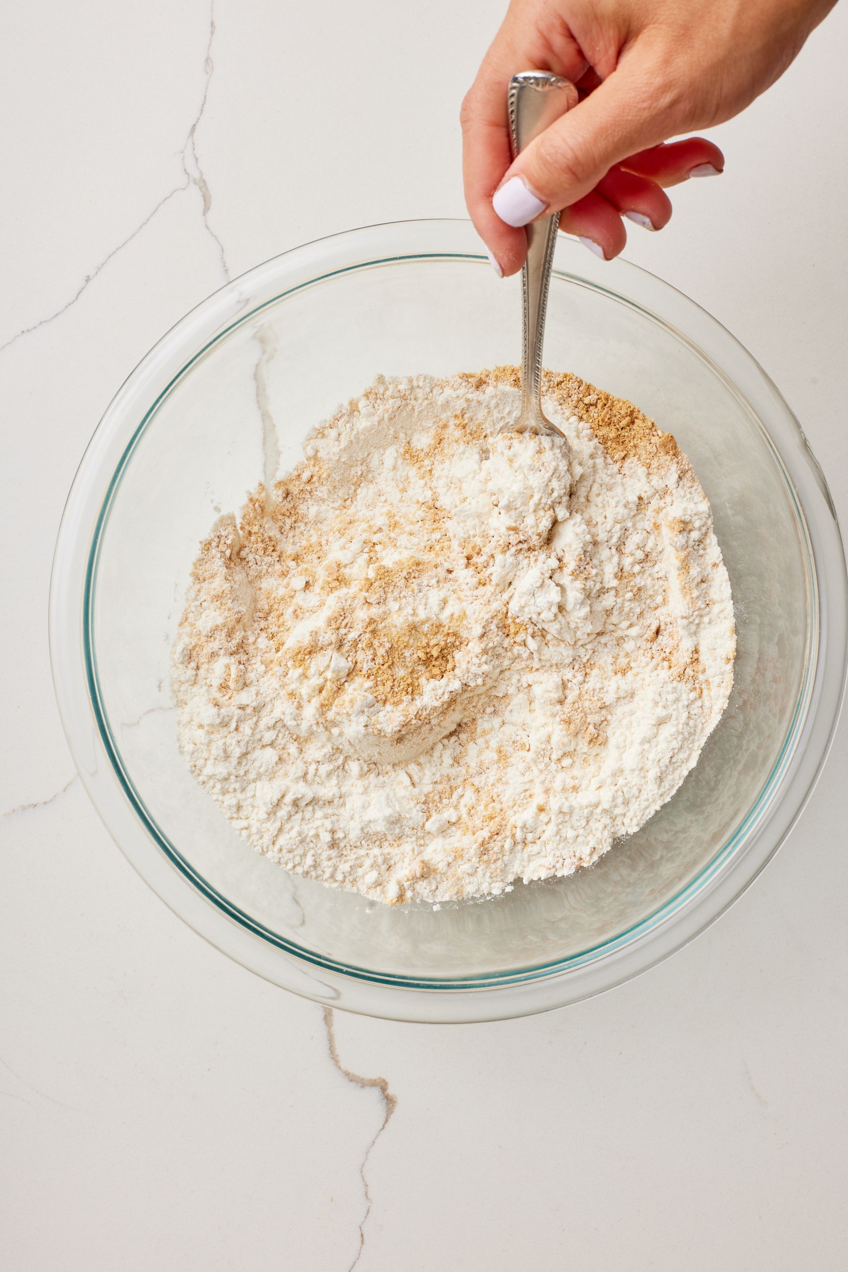 Step-by-step instructions on how to make Key Lime Pie Cookies: mix dry ingredients together in a bowl.