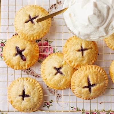 Top down view of Blueberry Pie Cookies served with a bowl of softly whipped cream.