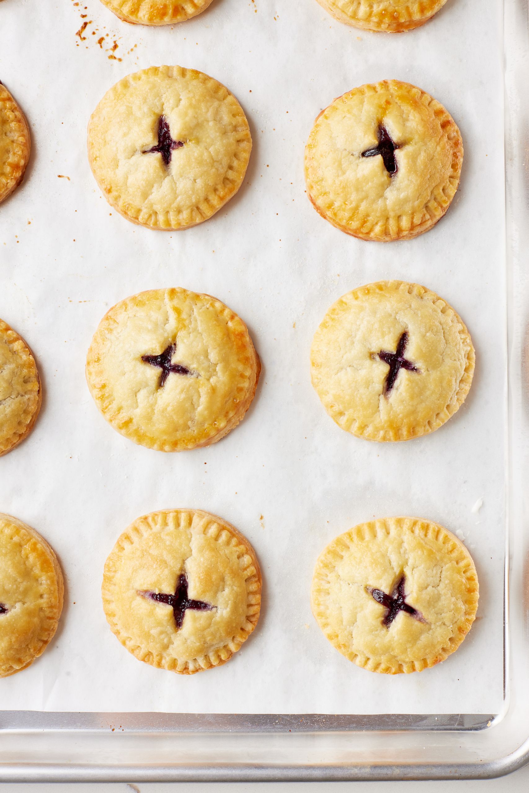 Top down view of a tray of Blueberry Pie Cookies with golden crust. 