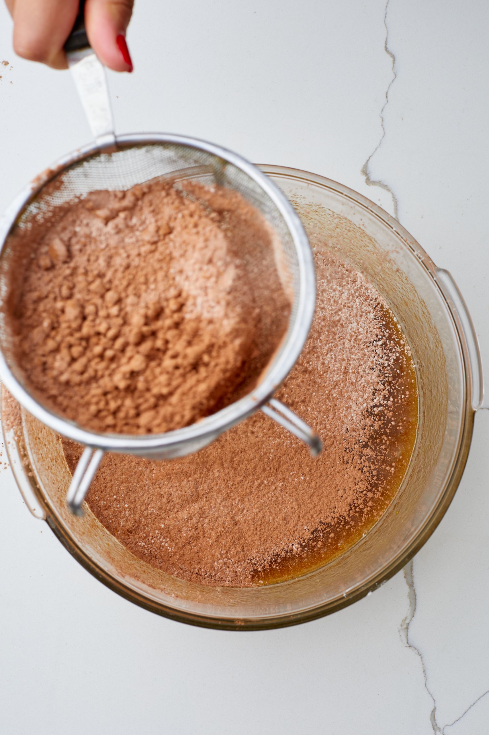 Step-by-step instructions on how to make Butterscotch Brownies: sift dry ingredients to mix with the wet. 