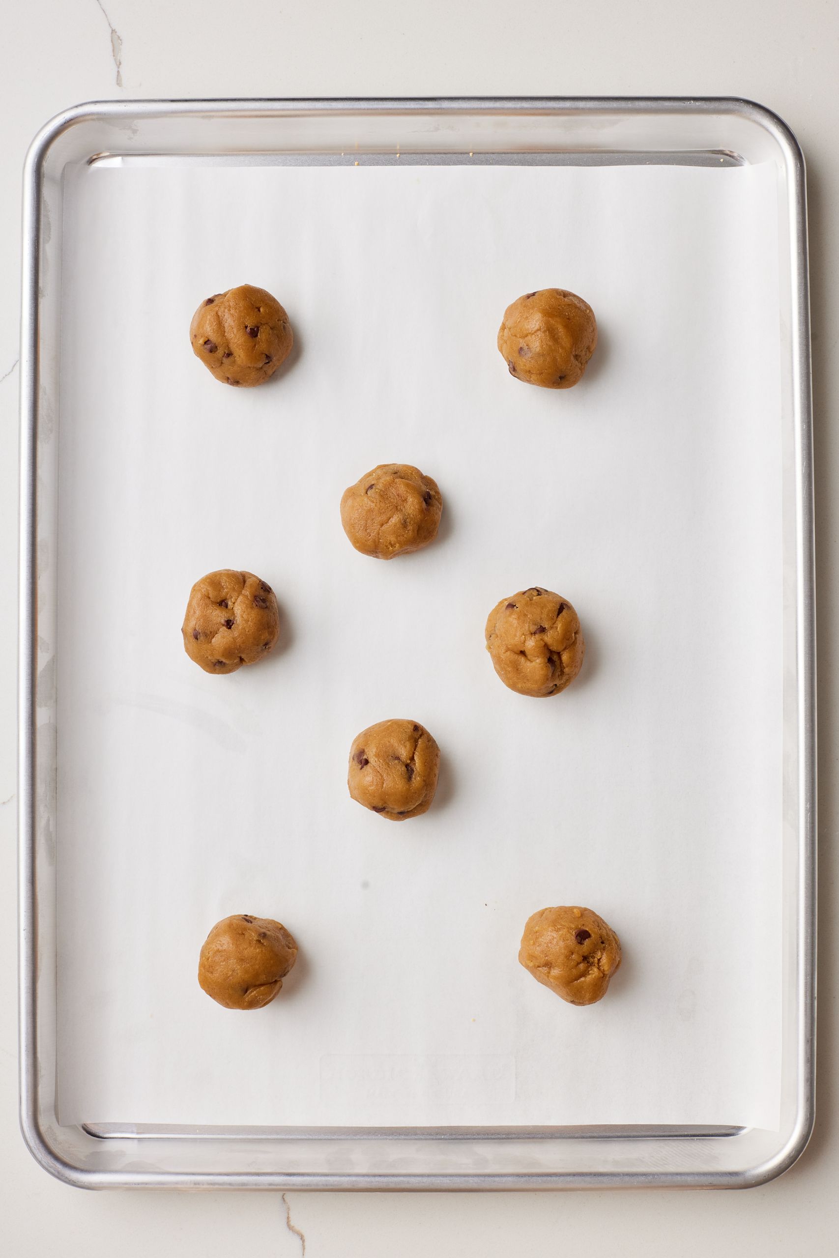 Portion the dough and roll them into balls, put on a baking tray. 