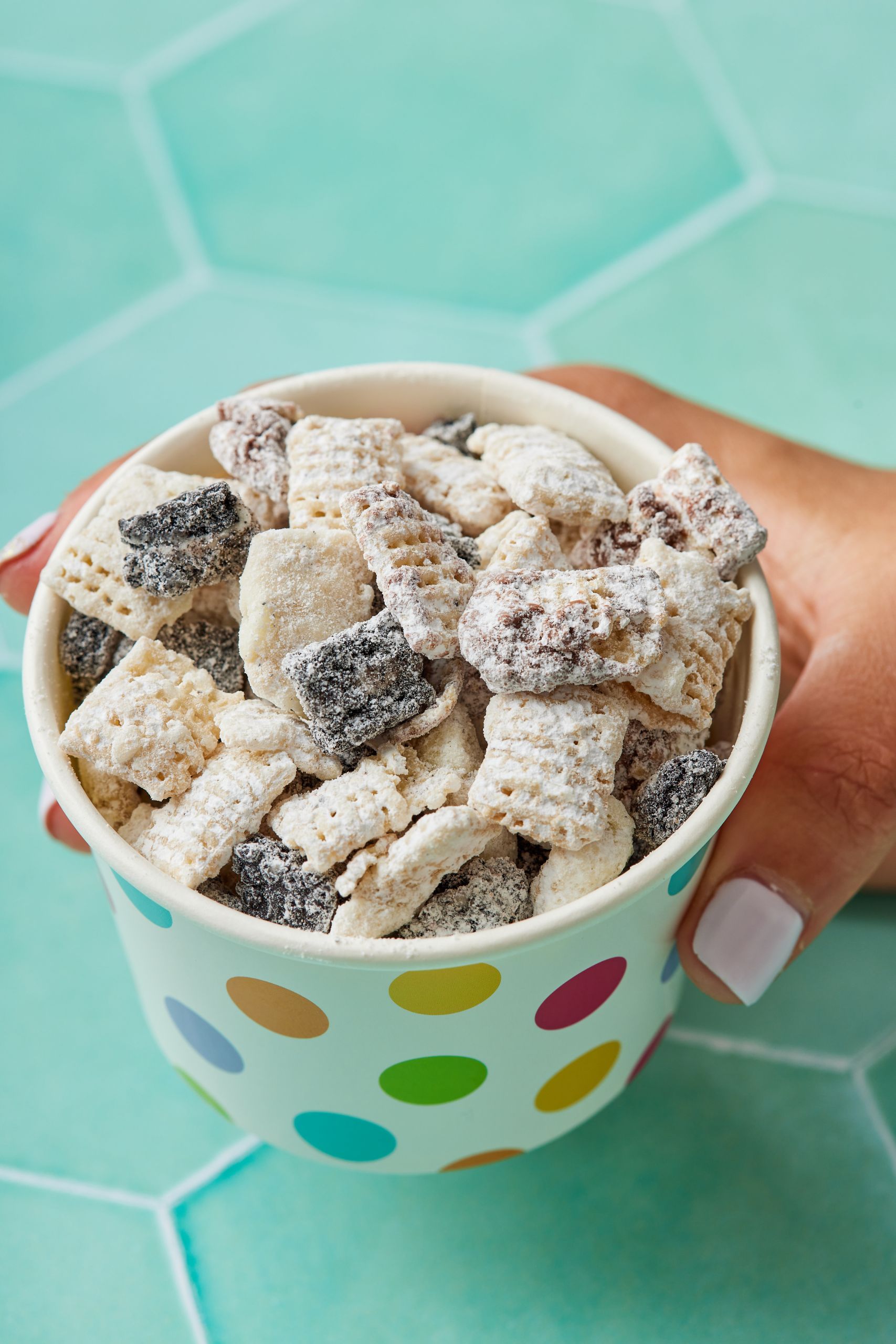 Cookies and cream muddy buddies6 A paper cup of Cookies and Cream Muddy Buddies