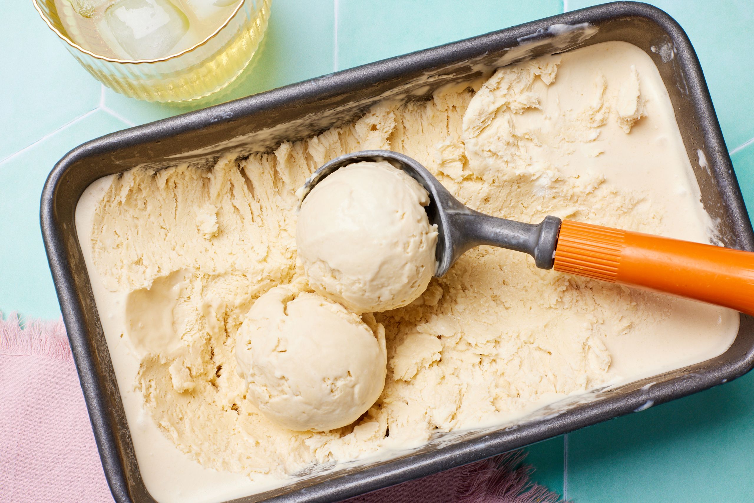 Whiskey Ice Cream in loaf tin with two scooped ice cream balls.
