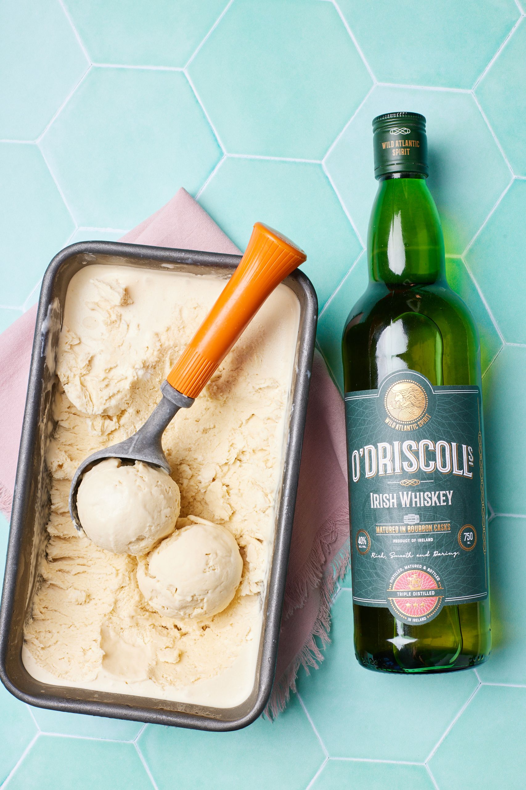 Whiskey Ice Cream stored in a loaf tin with a bootle of whiskey on the side.
