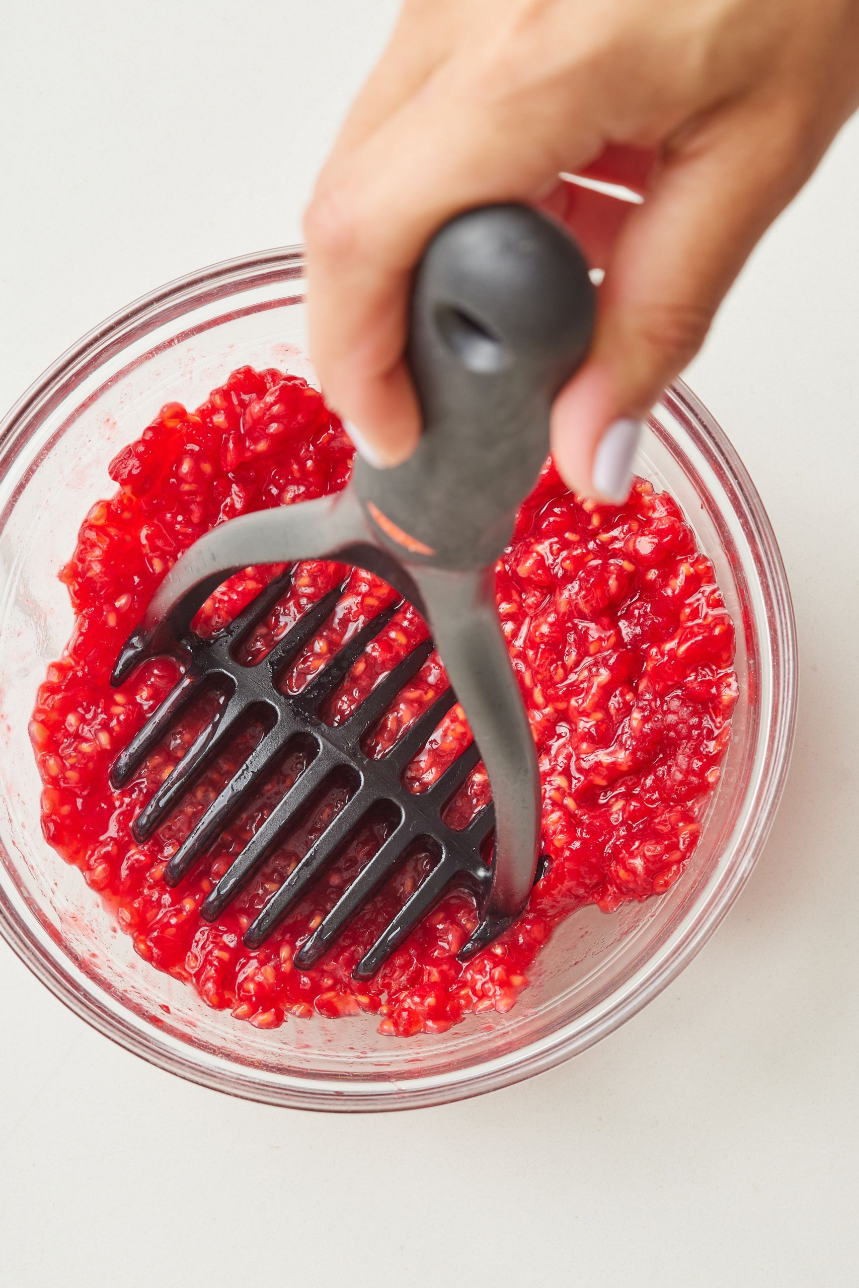Step-by-step instructions on how to make Cranachan: mash raspberries partially 