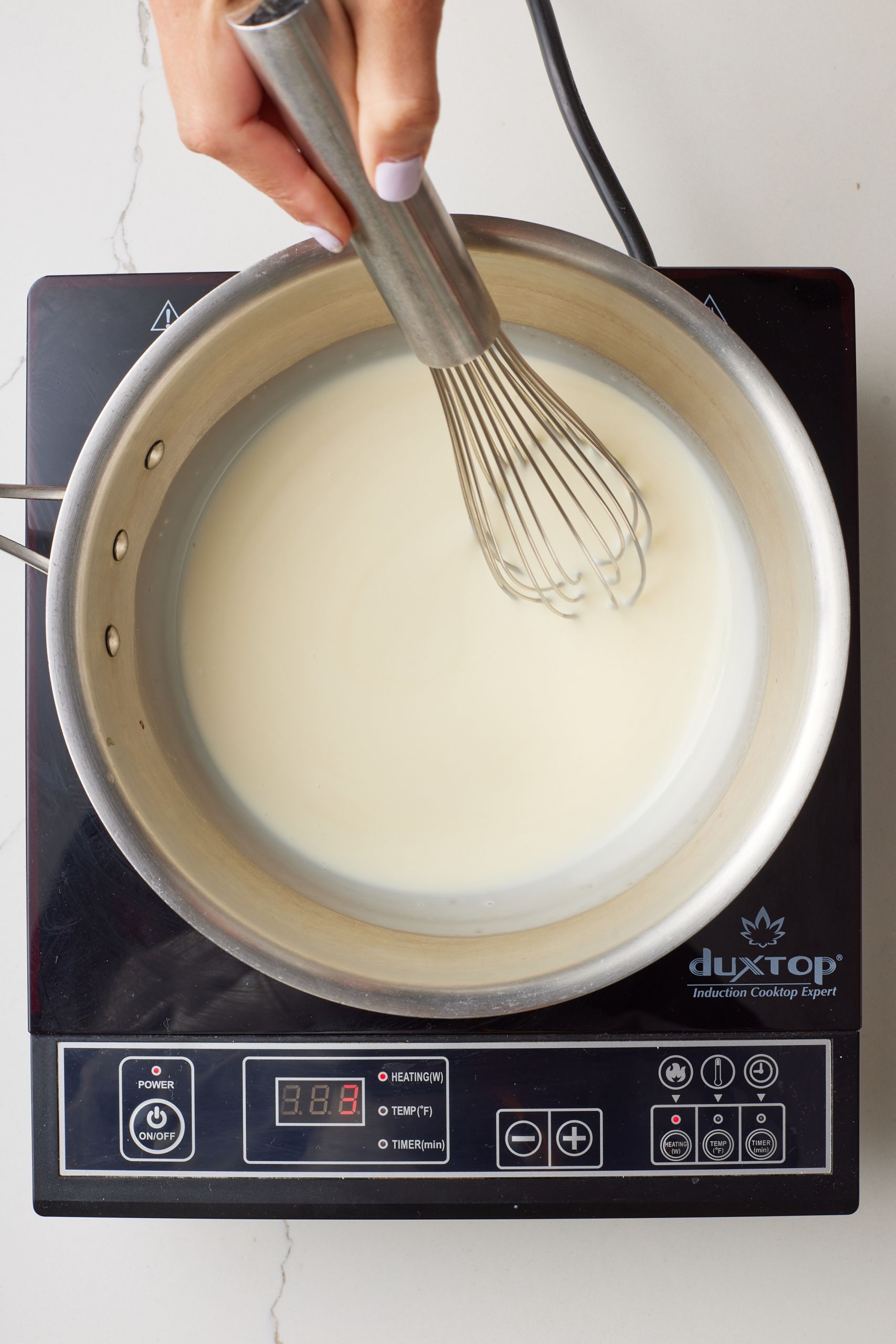 Step-by-step instructions on how to make Soft serve frozen yogurt: mix sugar and cream in a saucepan over medium heat