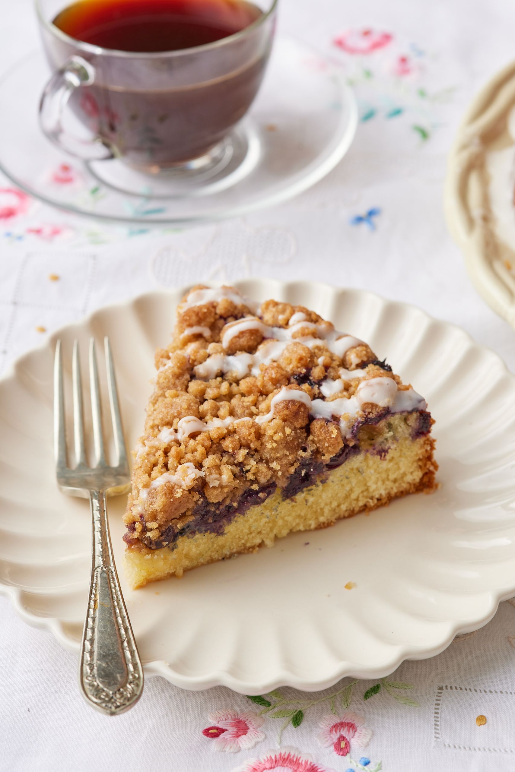A slice of coffee cake served with coffee.