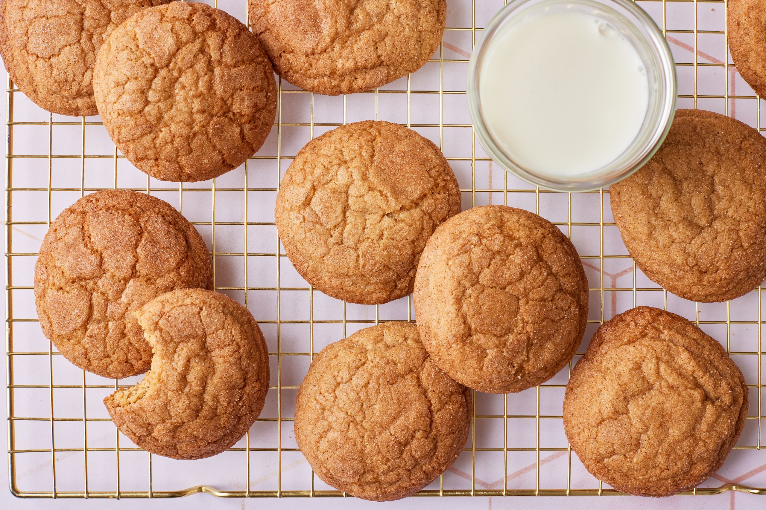 A top down view of Applesauce Cookies on the wire rack served with milk.
