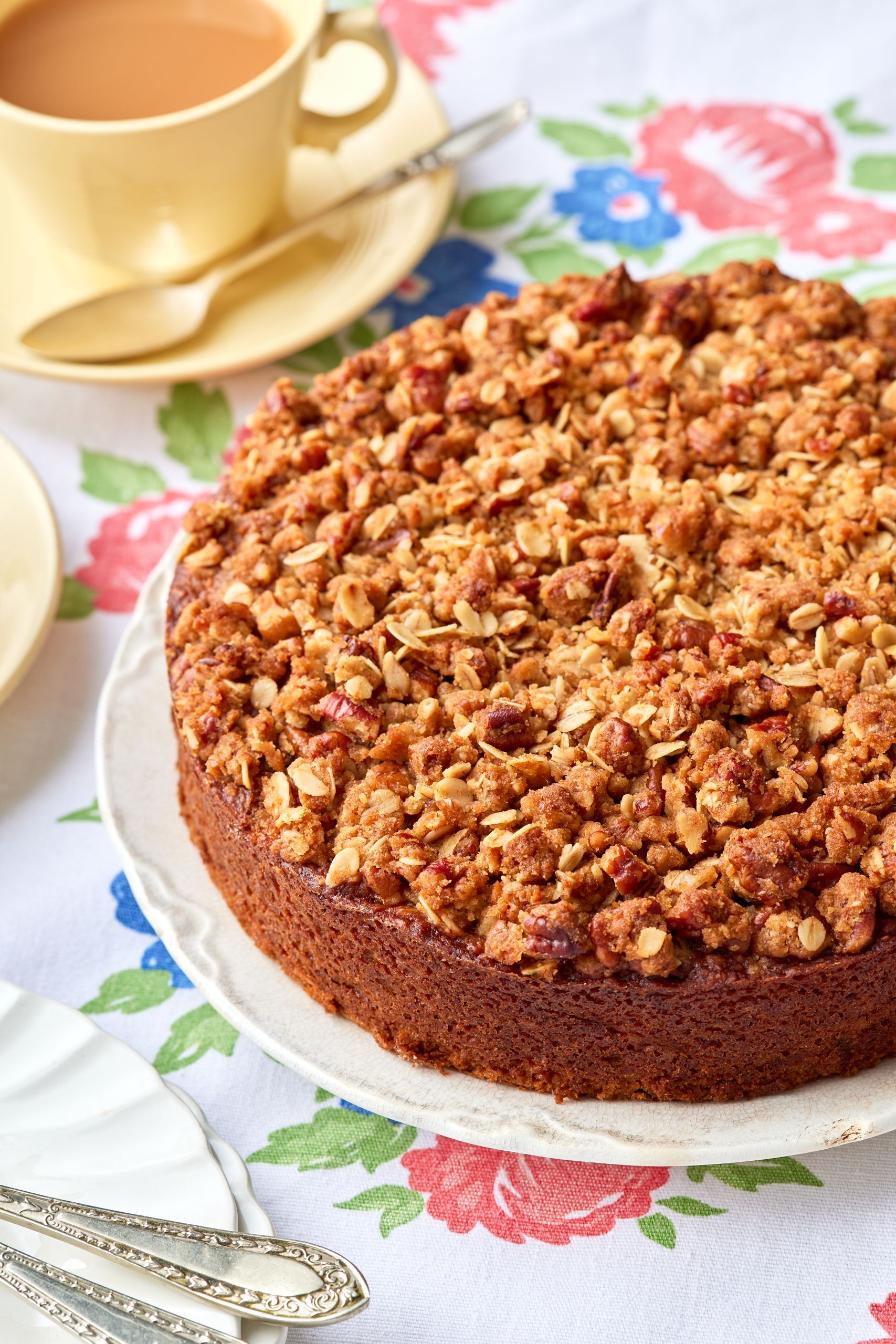 Apple Oatmeal Cake served on a platter with tea on the side. 