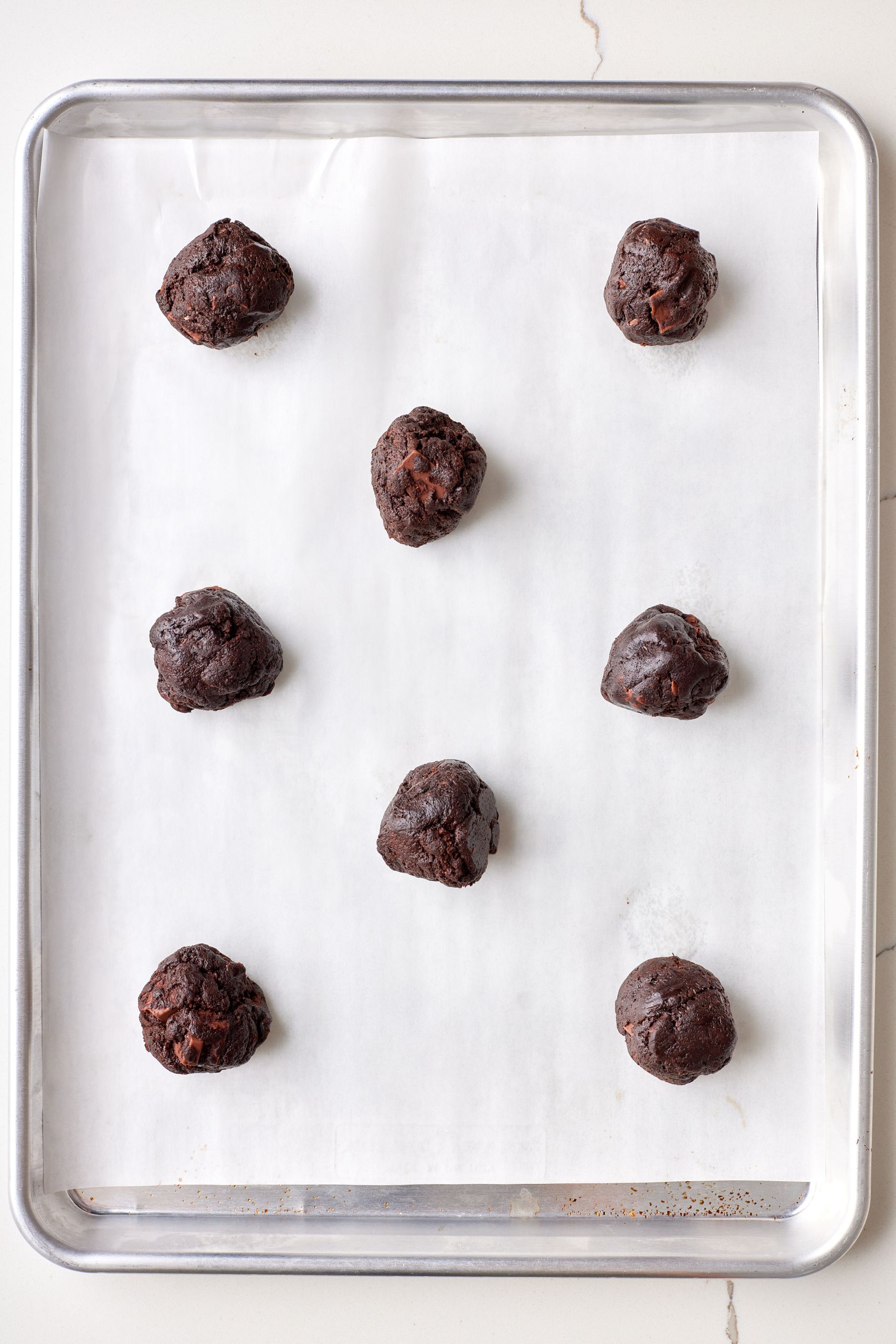 Divide the dough into even cookie balls and arrange them 2 inches apart on the parchment-lined baking sheet.