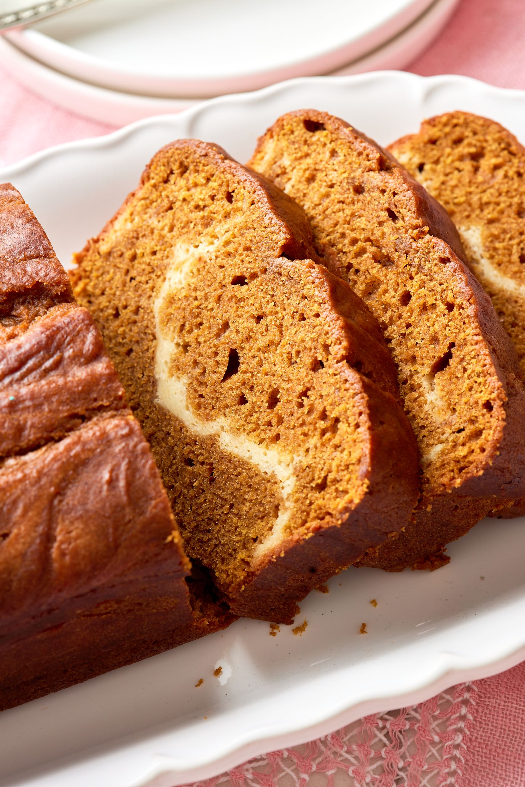 Pumpkin Cream Cheese bread slices show the moist crumb with swirls of cream cheese. 