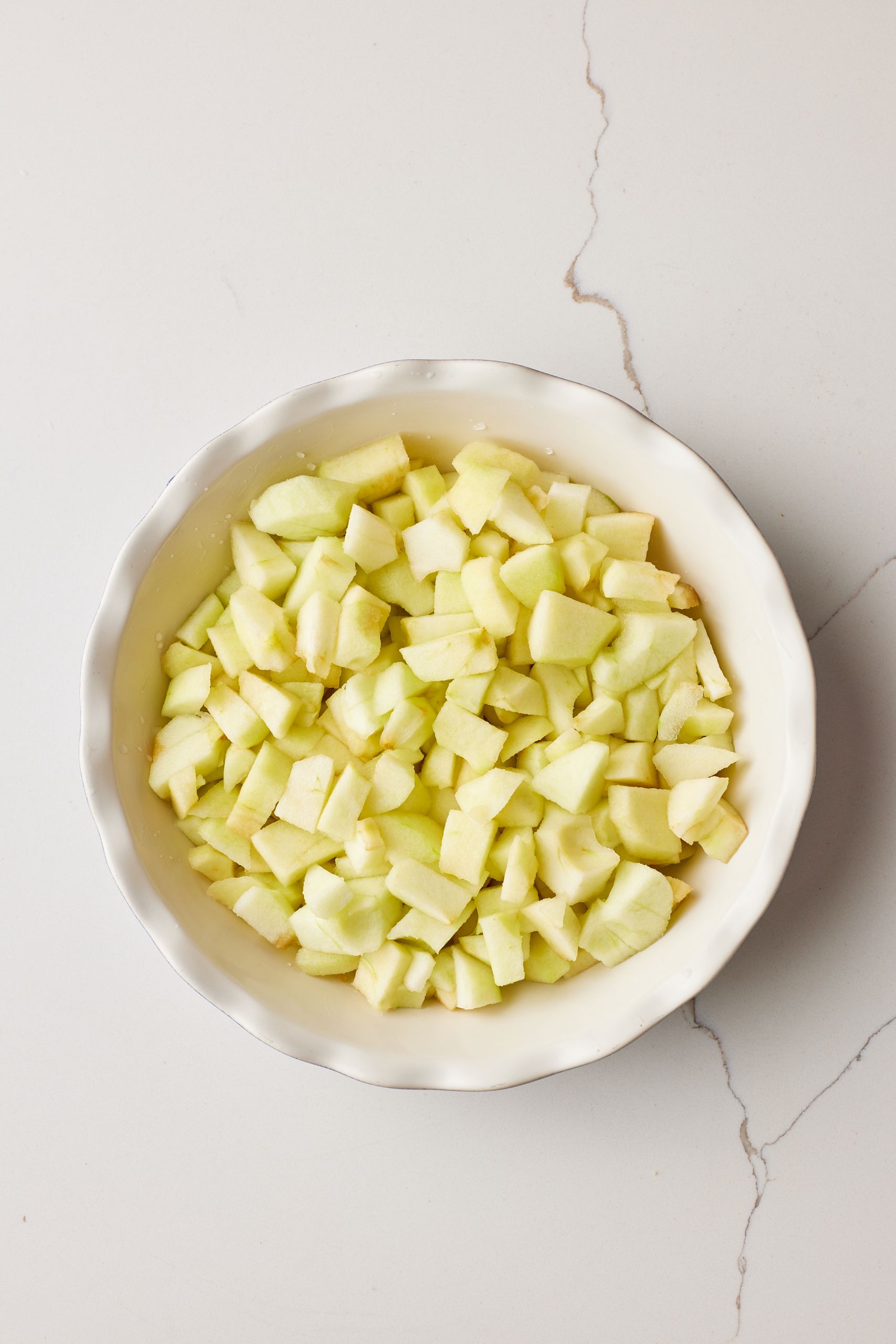 peel, core, and chop apples then arrange them in the dish. 