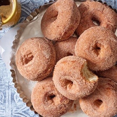 A top-down view of a plate of potato donuts.