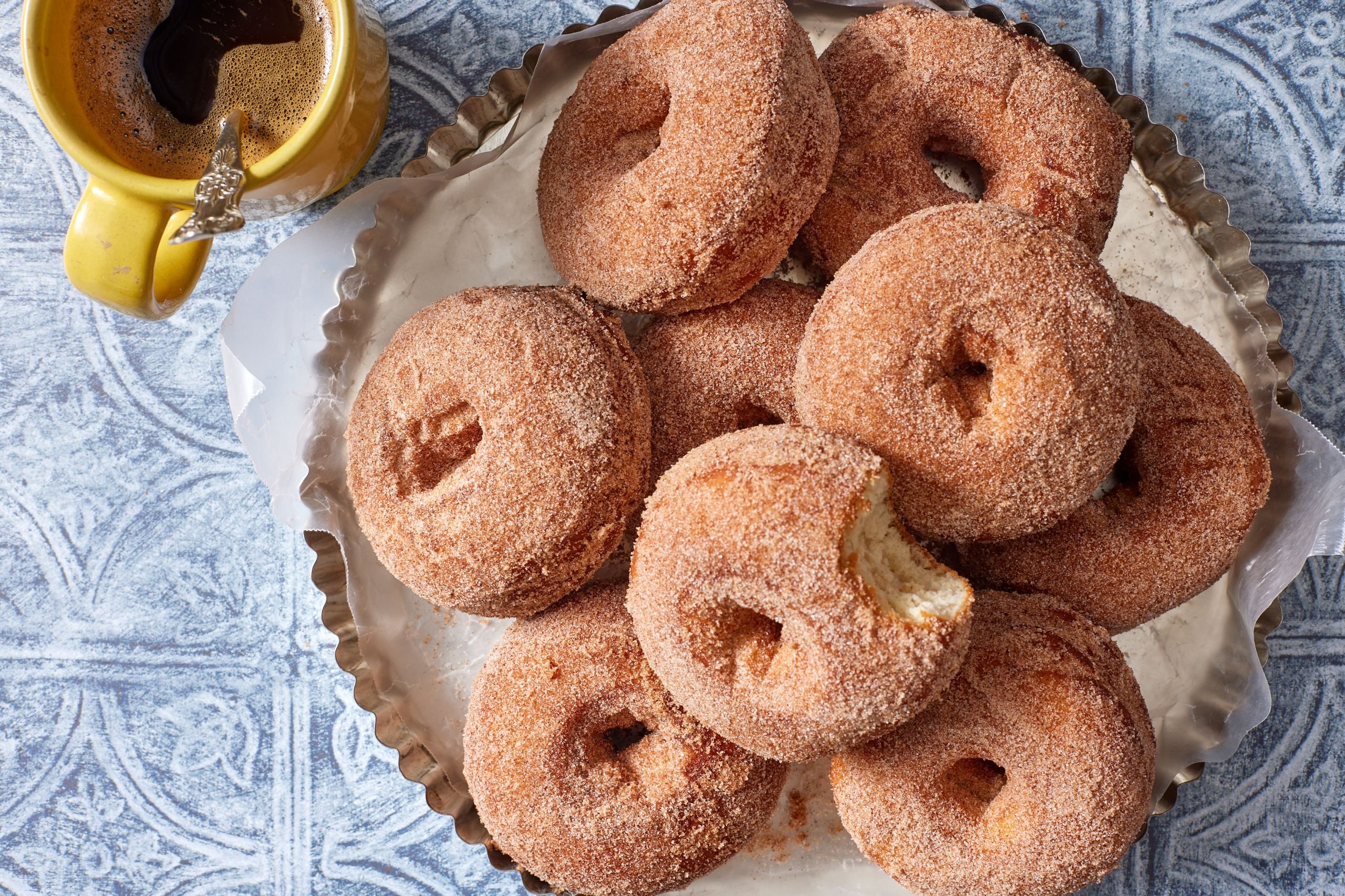 A plate od potato donuts served with coffee