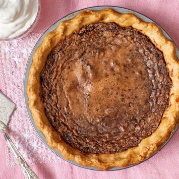 Chocolate Chess Pie with golden crust and silky filling served with ice cream on the side.