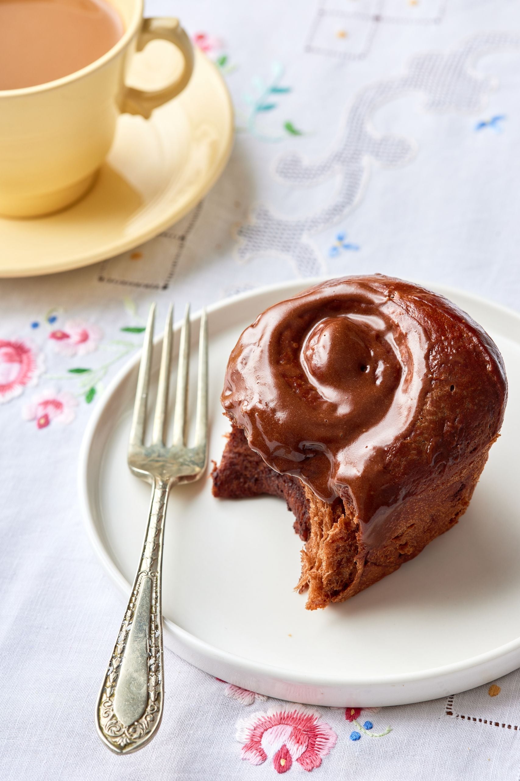 One chocolate cinnamon roll with one bite taken. 