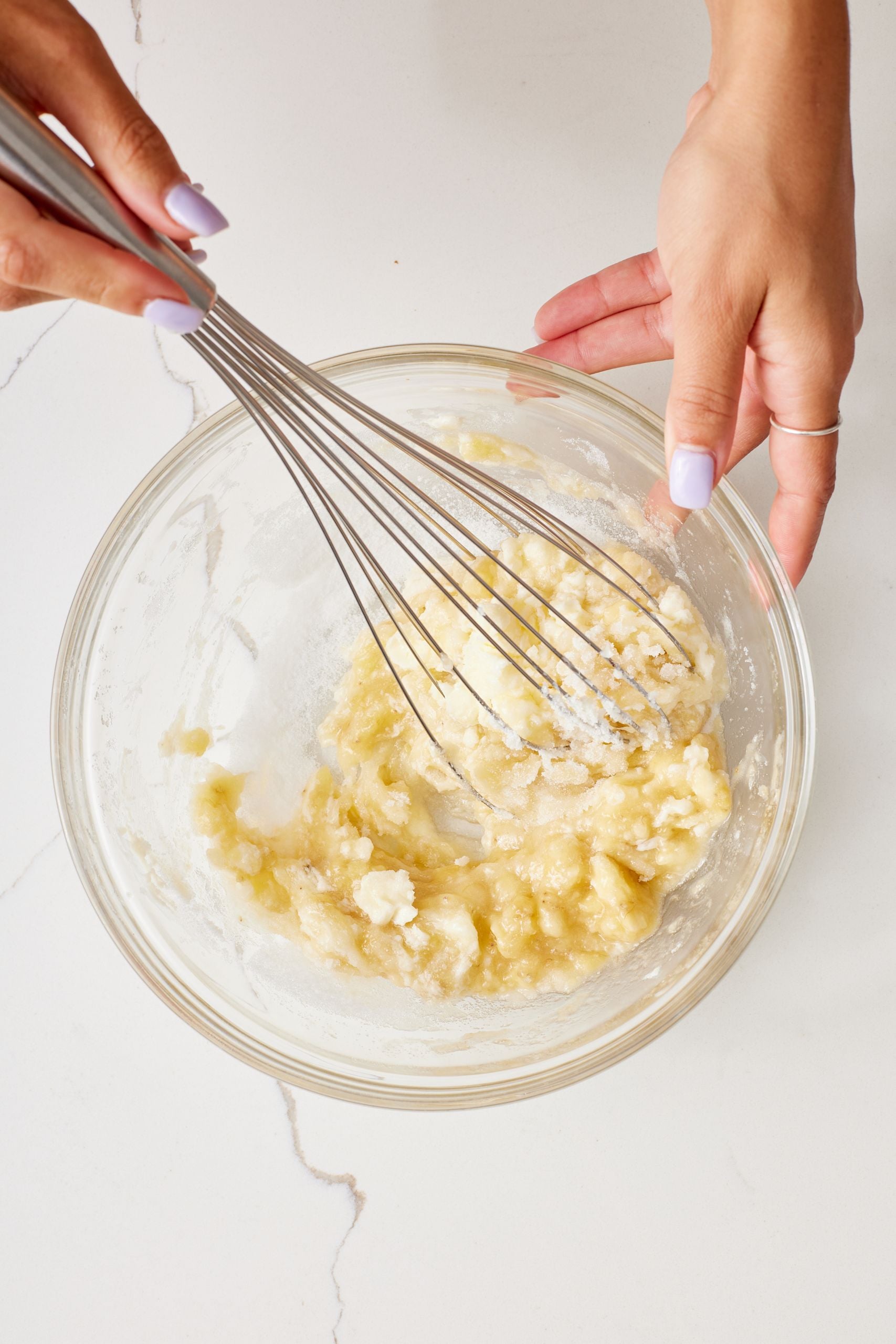Step-by-step instructions on how to make cranberry banana bread: In a medium bowl, mix together the banana, sugar, and butter until smooth.
