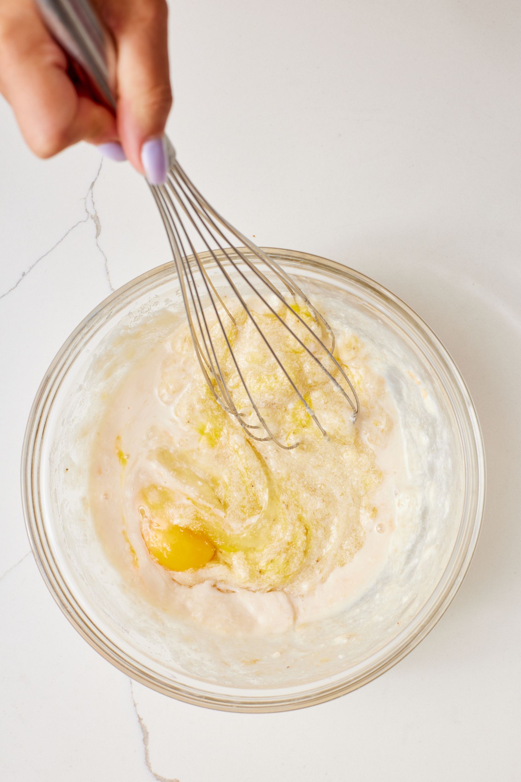 Whisk in the eggs, one at a time, followed by the milk and vanilla extract.