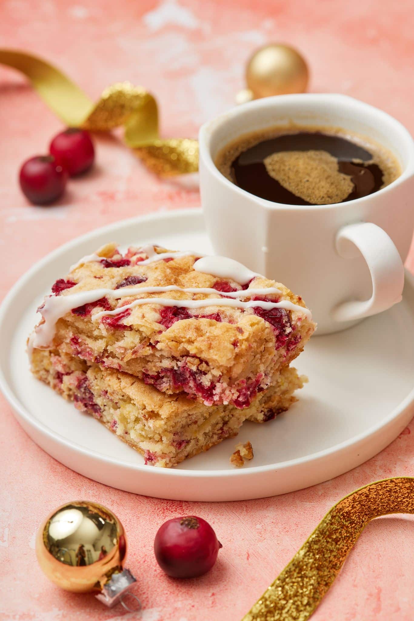 Cranberry bar served with a cup of coffee.