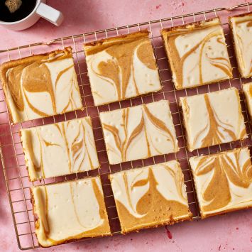 Pumpkin cheesecake bars served with coffee.