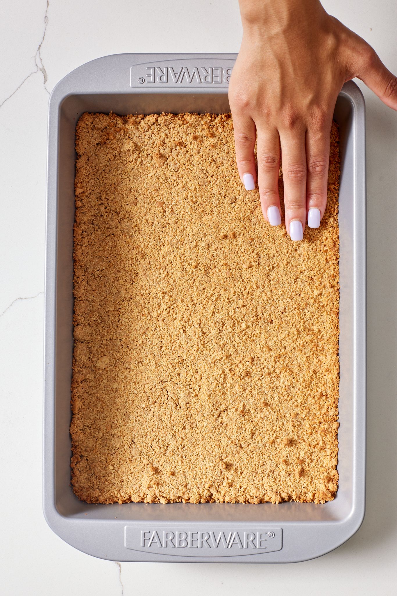Pumpkin Cheesecake Bars3 Spread graham cracker crumbs into the pan.