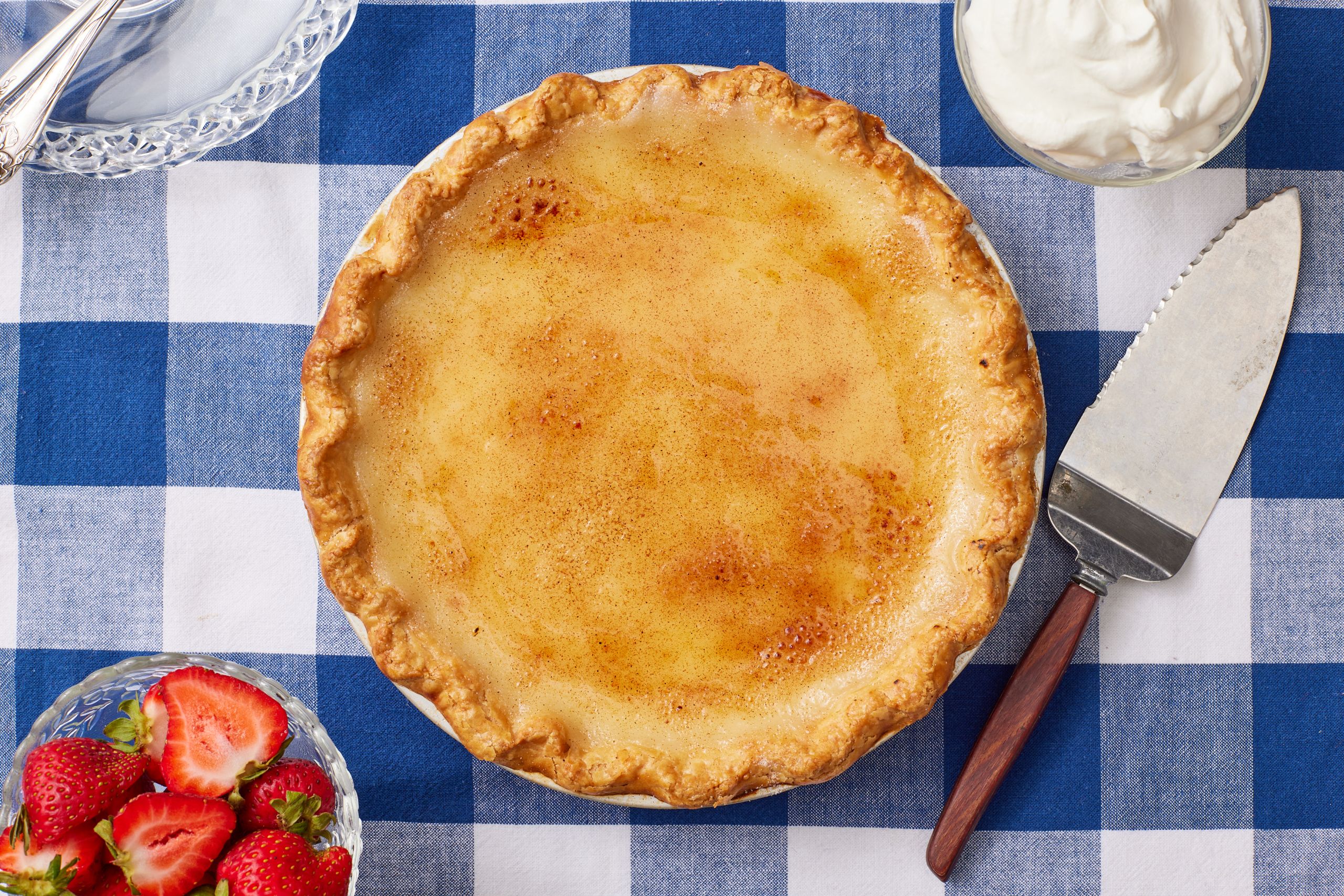 Golden Sugar Cream Pie served wit whipped cream and fresh strawberries on the side.