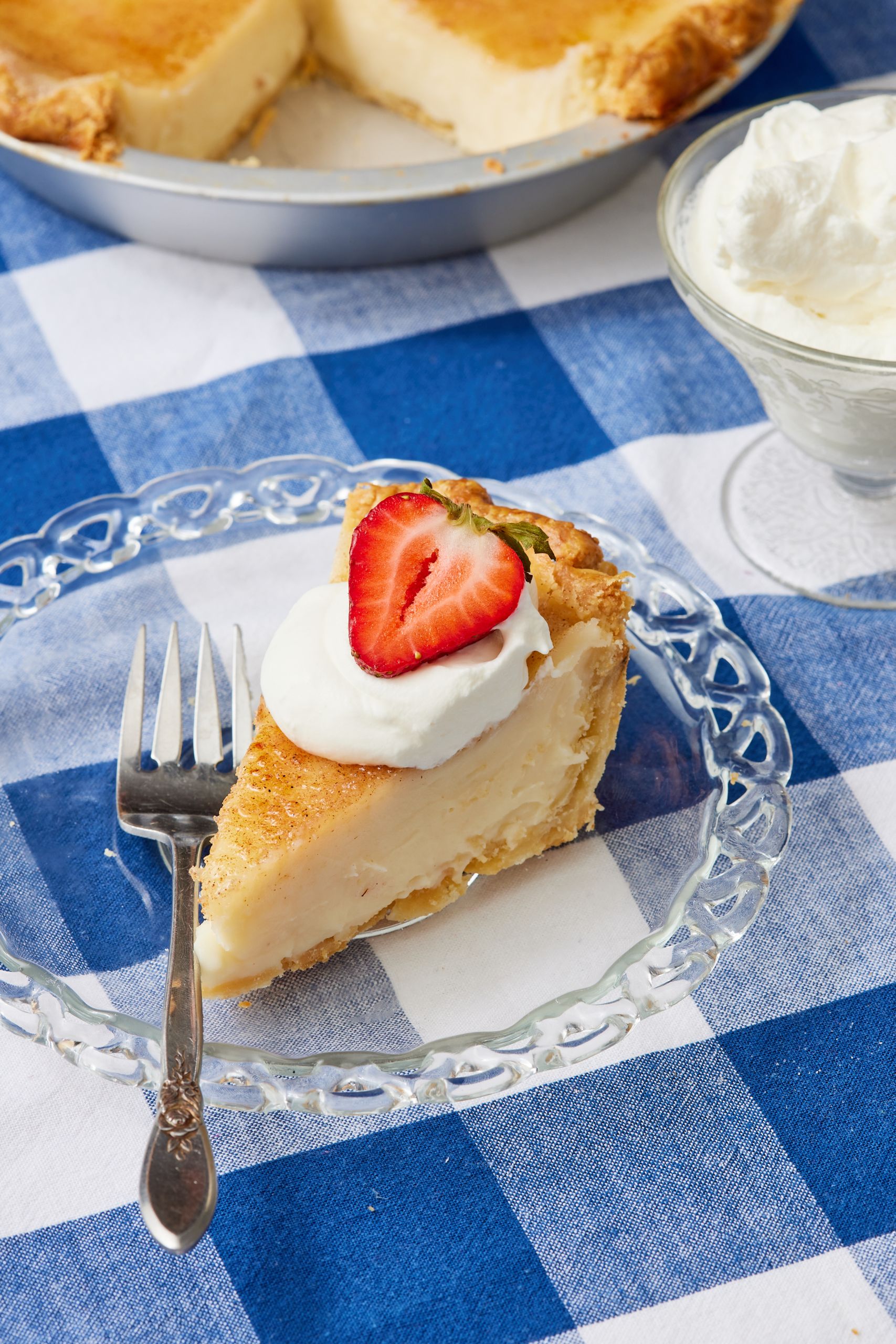 Sugar Cream Pie12 A slice of Sugar Cream Pie served with whipped cream and fresh strawberry.