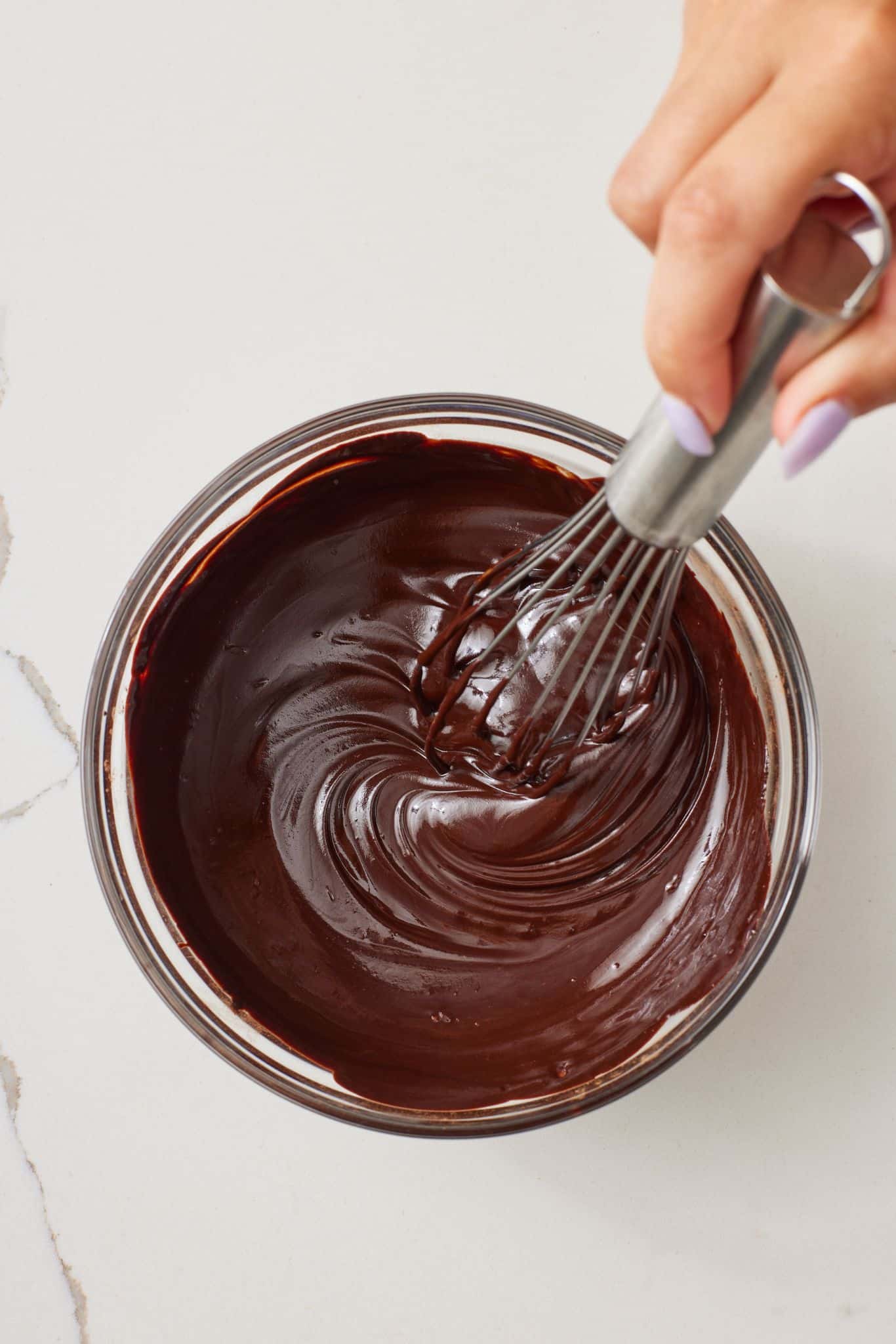 Step-by-step instructions on how to make Peppermint Chocolate Cookies: Melt chocolate, butter, and cocoa powder.