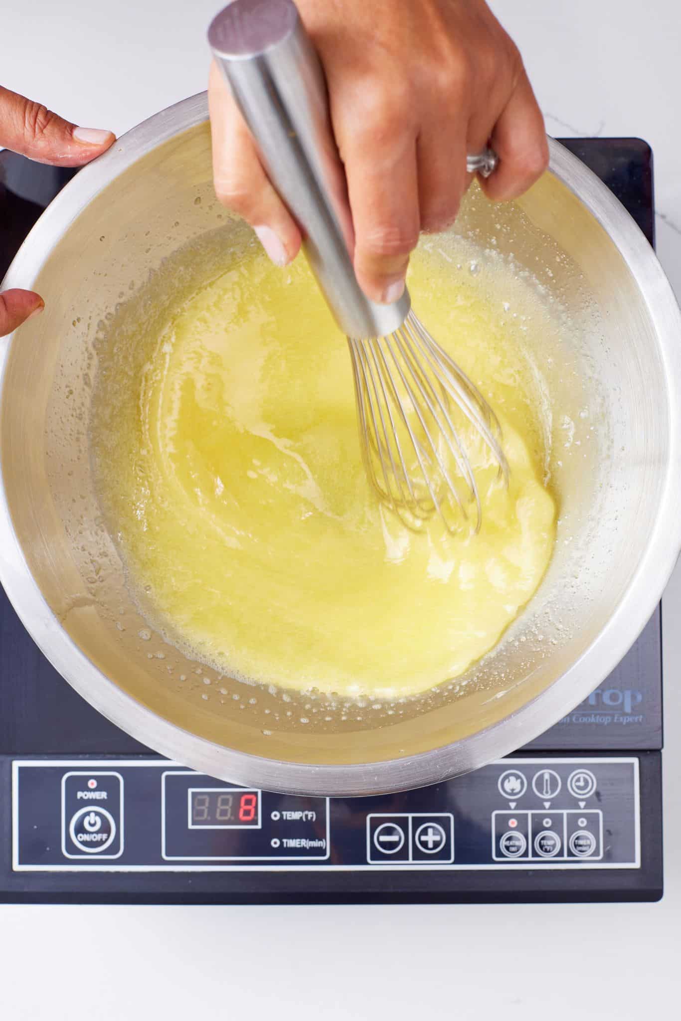 Step-by-step instructions on how to make French Silk Pie: heat sugar and eggs in a bowl. 