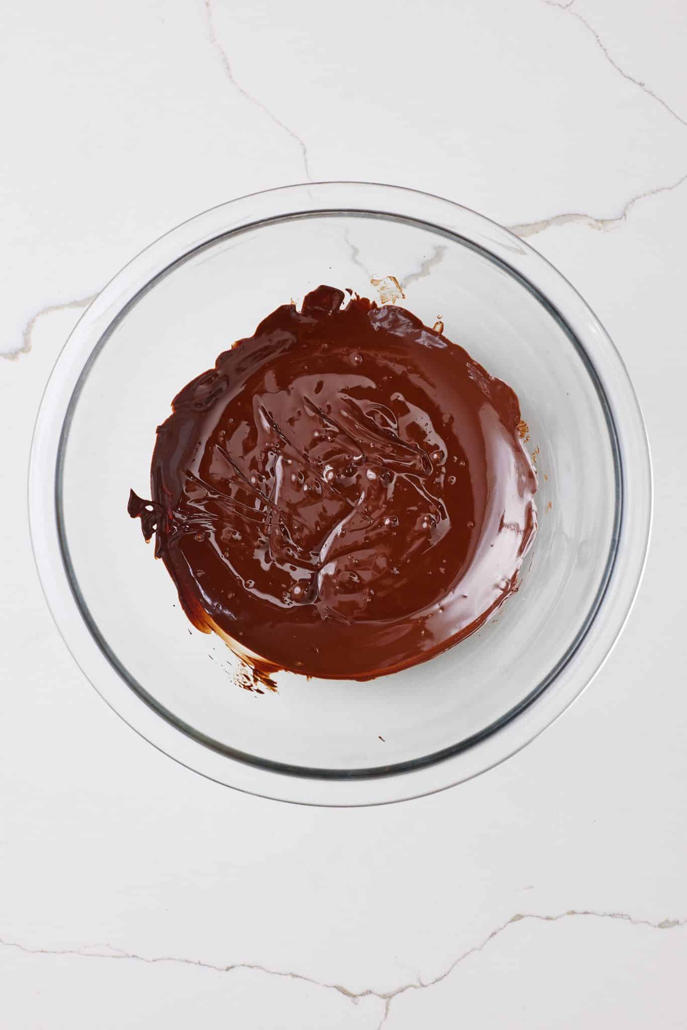 Melted chocolate in a glass bowl. 