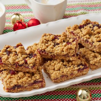 Cranberry Oatmeal Bars served on a platter with two cups of coffee on the side.