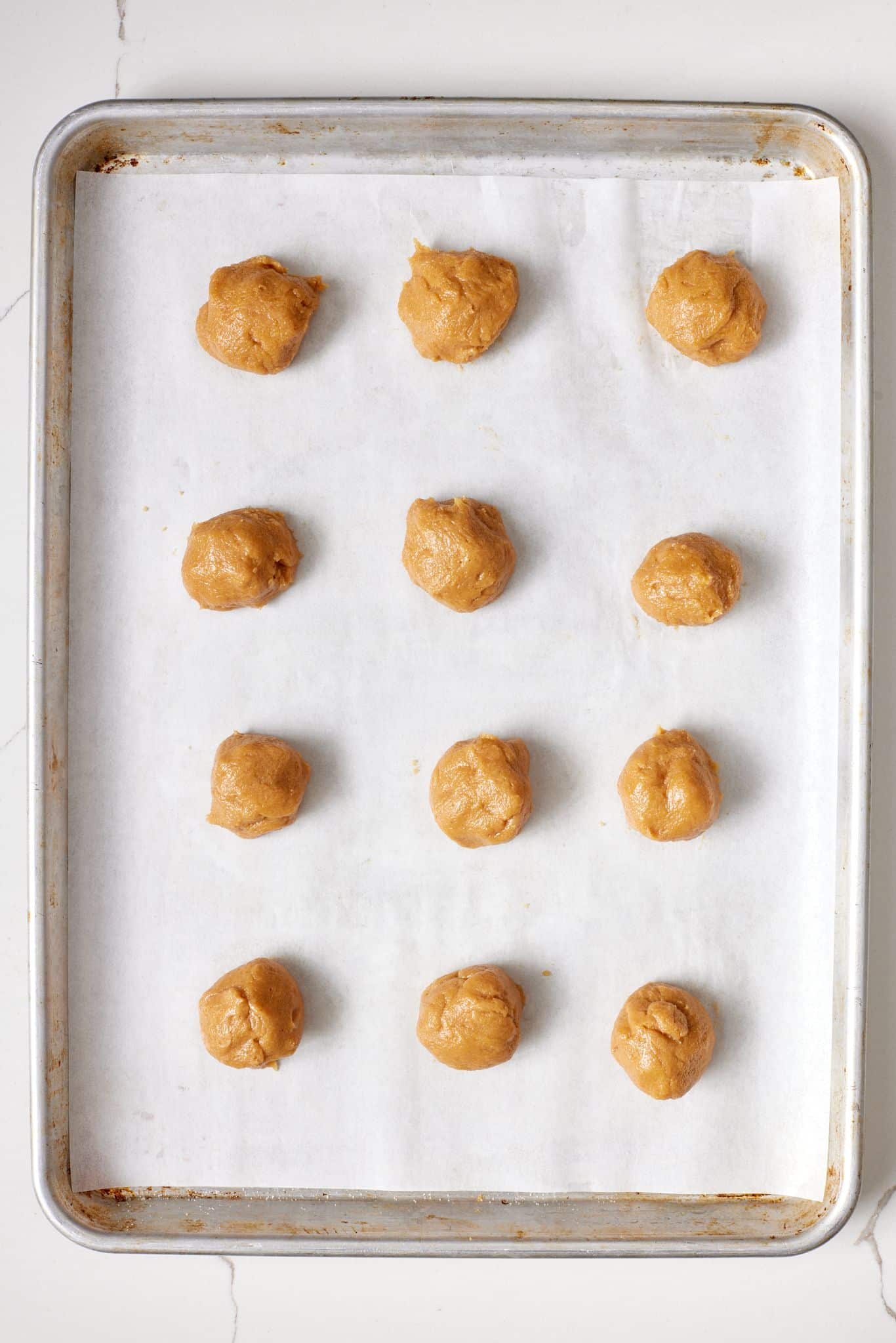 Portion peanut butter blossoms dough and place them on the baking sheet. 