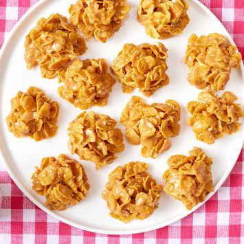 A top down view of a platter of Peanut Butter Chews served with milk on the side.