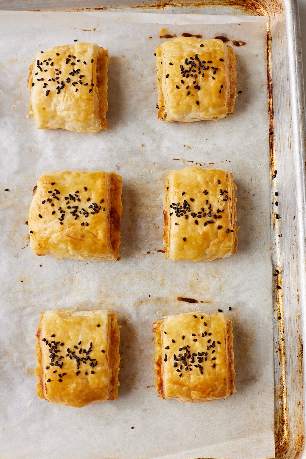Cheese and Onion Rolls14 Cheese and Onion Rolls on the baking tray baked golden brown.