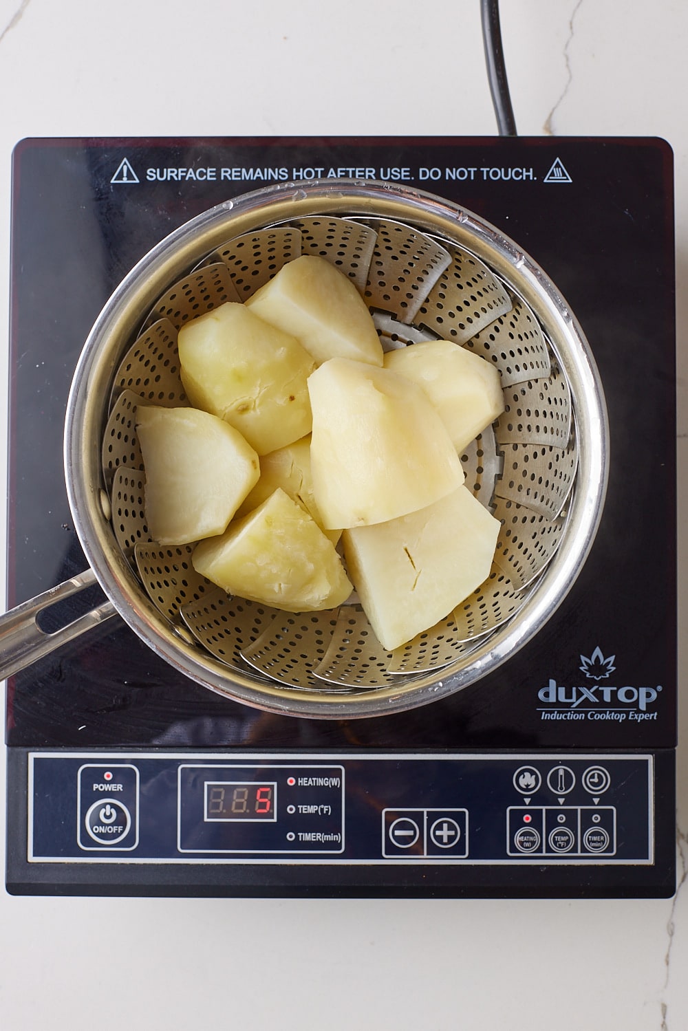 Cheese and Onion Rolls4 Cook potatoes for cheese and onion roll in a pot with a steamer rack until tender.