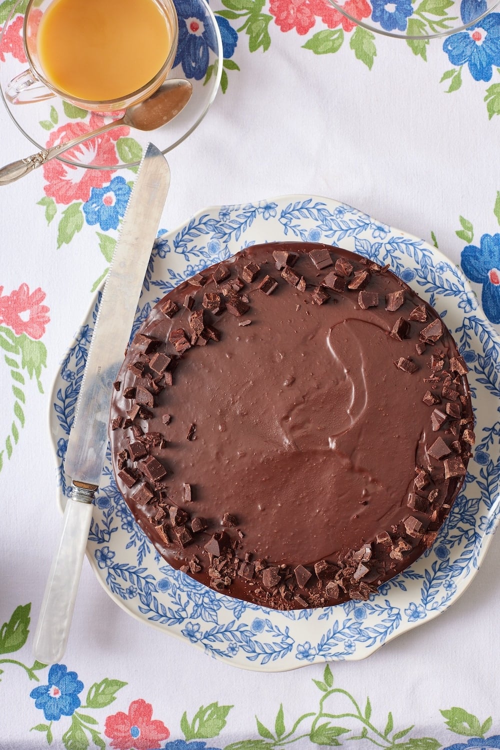 Chocolate Biscuit Cake13 Top-down view of a chocolate biscuit cake with glossy ganache , served with tea on the side.