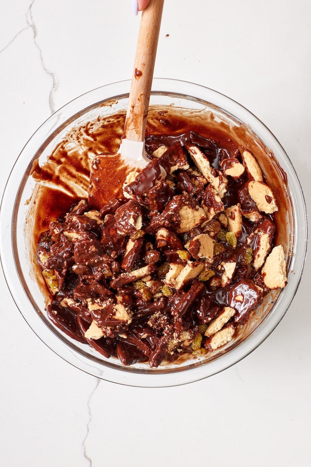 Chocolate Biscuit Cake5 Mix crushed digestive biscuits in the chocolate mixture.