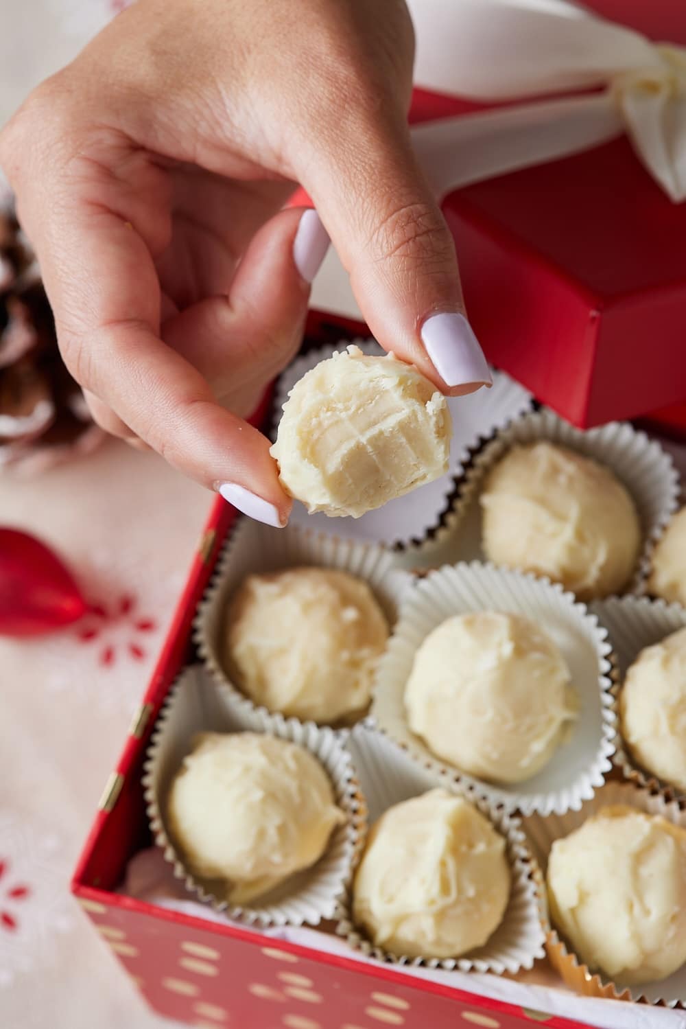 Eggnog Truffles9 An eggnog truffle with one bite taken over the box.