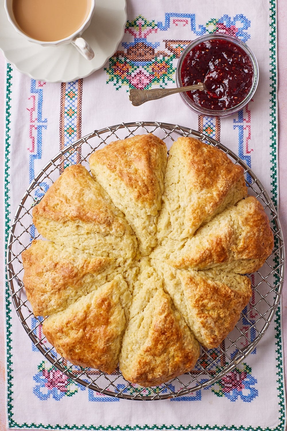 Irish Soda Bread Scones7 Top down view of a golden brown soda bread scone on the wire rack served with jam and tea.