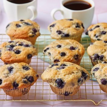 Sourdough Blueberry Muffins on the wire rack served with coffee.