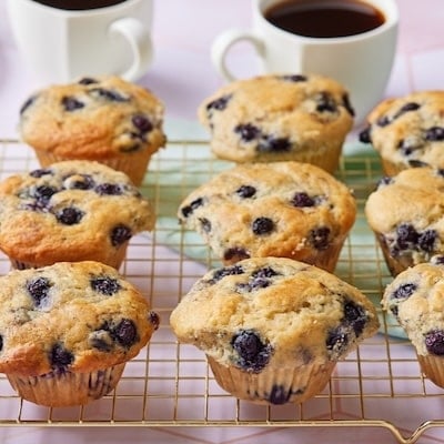 Sourdough Blueberry Muffins on the wire rack served with coffee.