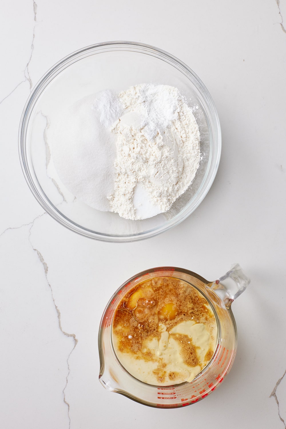 Sourdough Blueberry Muffins2 Sourdough Blueberry Muffins dry ingredients mixed in a bowl and wet ingredients mixed in a jug.