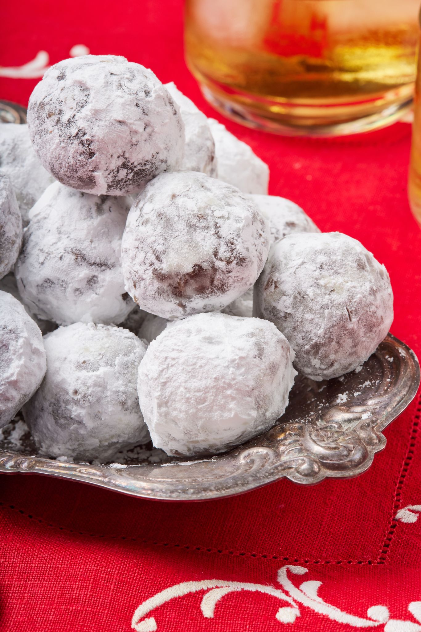 A stack of Whiskey Balls coated with powdered sugar. 